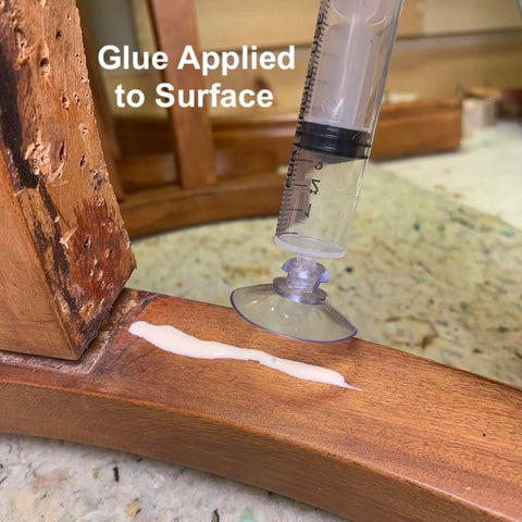 wood glue injection into split wood crack with clamp
